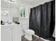 Bright bathroom with white vanity, modern fixtures, wood floors, and natural light from the window at 1048 Indian Hills Pkwy, Marietta, GA 30068