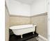 Bathroom showcasing a classic clawfoot tub and neutral tile at 1048 Indian Hills Pkwy, Marietta, GA 30068