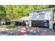 Modern two-story home featuring an attached two-car garage and brick-paved driveway and walkway at 1048 Indian Hills Pkwy, Marietta, GA 30068