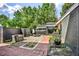 Cozy patio with brick flooring, planters, unique privacy fence and stone landscaping offering a tranquil outdoor space at 1048 Indian Hills Pkwy, Marietta, GA 30068