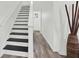 Staircase with black and white painted steps and wood-look flooring at 1048 Indian Hills Pkwy, Marietta, GA 30068