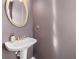 Chic half-bathroom featuring a modern sink, oval mirror, and stylish fixtures at 1107 Park Row South Se, Atlanta, GA 30312