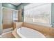 Luxurious bathroom featuring a soaking tub, shower, and natural light at 1107 Park Row South Se, Atlanta, GA 30312