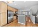 Bright kitchen featuring stainless steel appliances, wood cabinets, and hardwood floors at 1107 Park Row South Se, Atlanta, GA 30312