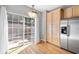 Bright kitchen area with stainless steel refrigerator, cabinets, and sliding glass doors leading outside at 1107 Park Row South Se, Atlanta, GA 30312
