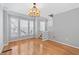 Spacious living room with hardwood floors, large windows, and a decorative chandelier at 1107 Park Row South Se, Atlanta, GA 30312