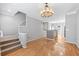 Open-concept space with hardwood floors, stairs, and views into the kitchen and dining area at 1107 Park Row South Se, Atlanta, GA 30312