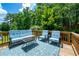 Inviting back deck with blue and white patterned outdoor furniture, ideal for entertaining guests at 4108 Wyndam Hill Dr, Suwanee, GA 30024