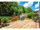 Spacious wooden deck with a grill, perfect for outdoor cooking and entertaining with views of the backyard at 4108 Wyndam Hill Dr, Suwanee, GA 30024