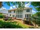 Expansive backyard view showcasing the deck, sunroom, mature trees, and well-kept lawn at 4108 Wyndam Hill Dr, Suwanee, GA 30024