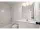 This bathroom features a shower and bath, bright lights, and neutral walls at 4108 Wyndam Hill Dr, Suwanee, GA 30024