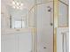 Modern bathroom featuring glass shower doors, white vanity, and bright lighting at 4108 Wyndam Hill Dr, Suwanee, GA 30024