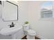 Stylish bathroom with a modern pedestal sink, black faucet, and bright natural light at 4108 Wyndam Hill Dr, Suwanee, GA 30024