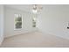 Bright and airy bedroom with neutral walls and carpet and natural light from two windows at 4108 Wyndam Hill Dr, Suwanee, GA 30024
