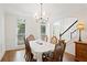 Bright dining room with wood floor and trim features a view to front entryway, a table and seating for six at 4108 Wyndam Hill Dr, Suwanee, GA 30024