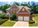 Beautiful two-story brick home with a manicured lawn and a two-car garage at 4108 Wyndam Hill Dr, Suwanee, GA 30024