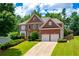 Two-story brick home with mature landscaping and a spacious driveway at 4108 Wyndam Hill Dr, Suwanee, GA 30024
