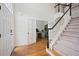 Spacious foyer with hardwood floors, staircase, and an office with French doors at 4108 Wyndam Hill Dr, Suwanee, GA 30024