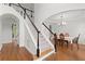 Bright foyer with hardwood floors, staircase with black and white railings, and arched doorways leading to other rooms at 4108 Wyndam Hill Dr, Suwanee, GA 30024