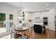 Charming breakfast nook adjoins the spacious kitchen, featuring white cabinetry, stainless steel appliances, and modern accents at 4108 Wyndam Hill Dr, Suwanee, GA 30024