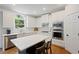 Modern kitchen features white cabinets, subway tile backsplash, stainless steel appliances, and a stylish island with seating at 4108 Wyndam Hill Dr, Suwanee, GA 30024