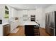 Bright kitchen with white cabinets, stainless steel appliances, and a large center island at 4108 Wyndam Hill Dr, Suwanee, GA 30024