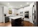 Modern kitchen featuring white cabinets, stainless steel appliances, and a dark wood island at 4108 Wyndam Hill Dr, Suwanee, GA 30024