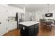 Kitchen island with white countertop, stainless steel appliances, and open floor plan at 4108 Wyndam Hill Dr, Suwanee, GA 30024