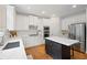 Bright kitchen features white cabinets, stainless appliances, subway tile backsplash, and island with marble countertop at 4108 Wyndam Hill Dr, Suwanee, GA 30024