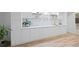 Modern kitchenette with white cabinets, shelving, and sleek countertops at 4108 Wyndam Hill Dr, Suwanee, GA 30024