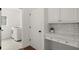 Bright laundry room with washer, dryer, storage cabinets and counter at 4108 Wyndam Hill Dr, Suwanee, GA 30024