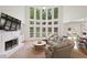 Bright open-concept living room showcasing fireplace, large windows, comfortable seating, and an open flow to the breakfast area at 4108 Wyndam Hill Dr, Suwanee, GA 30024