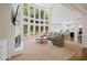 Spacious living room boasts a two story wall of windows, fireplace, and comfortable seating area with an open layout at 4108 Wyndam Hill Dr, Suwanee, GA 30024