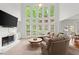 Bright living room with large windows, a fireplace, and comfortable seating at 4108 Wyndam Hill Dr, Suwanee, GA 30024