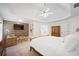Bright main bedroom featuring a tray ceiling, wood accent wall, and large windows at 4108 Wyndam Hill Dr, Suwanee, GA 30024