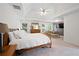 Spacious main bedroom with tray ceiling, wood-paneled wall, and natural light at 4108 Wyndam Hill Dr, Suwanee, GA 30024