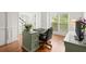 Bright office space with hardwood floors, view to front yard, traditional desk and chair at 4108 Wyndam Hill Dr, Suwanee, GA 30024