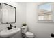 Modern powder room with white sink, black faucet, and decorative mirror at 4108 Wyndam Hill Dr, Suwanee, GA 30024