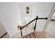 Elegant staircase with dark wood railing and views of the entryway below at 4108 Wyndam Hill Dr, Suwanee, GA 30024