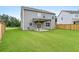 A spacious backyard featuring a well-maintained lawn and a covered patio area at 537 Garnet Dr, Acworth, GA 30101