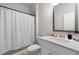 Bright bathroom with a sleek vanity, modern fixtures, and a shower with a white curtain at 537 Garnet Dr, Acworth, GA 30101