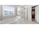 Bathroom featuring tub, separate shower and window at 537 Garnet Dr, Acworth, GA 30101