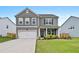 Traditional two-story home with green lawn, two-car garage, and manicured landscaping at 537 Garnet Dr, Acworth, GA 30101