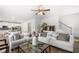 Open living room featuring hardwood floors, two sofas, and a ceiling fan at 537 Garnet Dr, Acworth, GA 30101