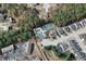 Aerial view of a community with a pool, tennis court, clubhouse, and multiple homes surrounded by trees at 942 Village View Cir, Loganville, GA 30052