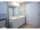 Bathroom features a large mirror, white vanity, toilet, and ceramic tile flooring at 942 Village View Cir, Loganville, GA 30052