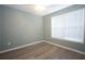 Bedroom features wood floors and a window that provides natural light at 942 Village View Cir, Loganville, GA 30052