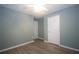 Bedroom features wood floors and two doors to provide easy access to other areas at 942 Village View Cir, Loganville, GA 30052
