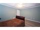 Bedroom features a decorative ceiling, wood floors, and a neutral paint scheme at 942 Village View Cir, Loganville, GA 30052