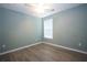 Bedroom features wood floors, a neutral paint scheme, and a window that provides natural light at 942 Village View Cir, Loganville, GA 30052